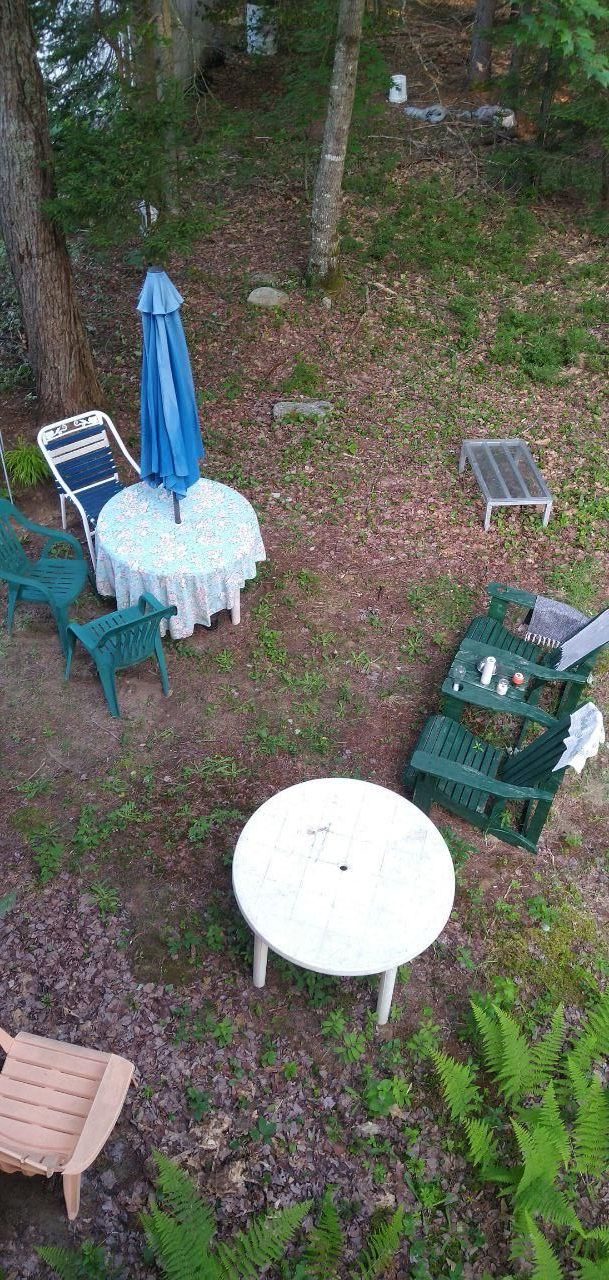 overhead view of camp patio with chairs umbrella and kayak at Bartertowne, Canaan New Hampshire