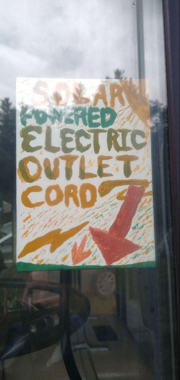 hand painted solar powered outlet sign at Bartertowne, Canaan New Hampshire