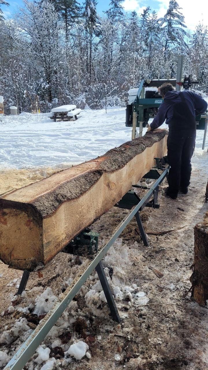 milling a timber beam in the snow at Bartertowne, Canaan New Hampshire