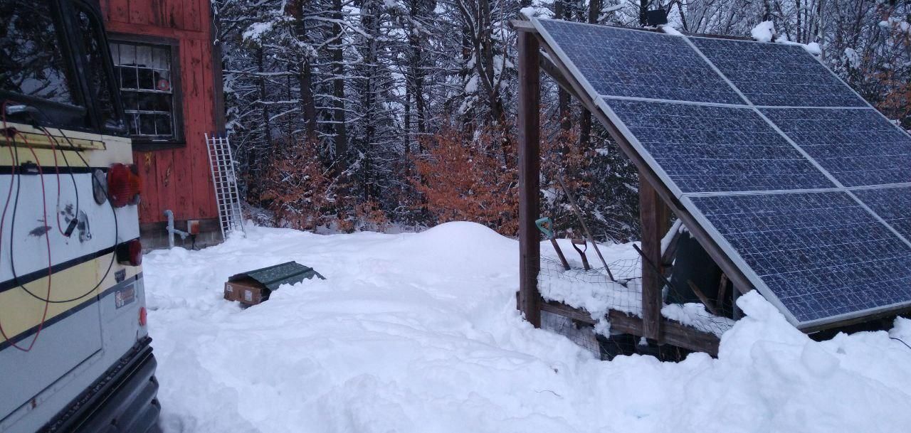 solar panel array beside bus in winter at Bartertowne, Canaan New Hampshire